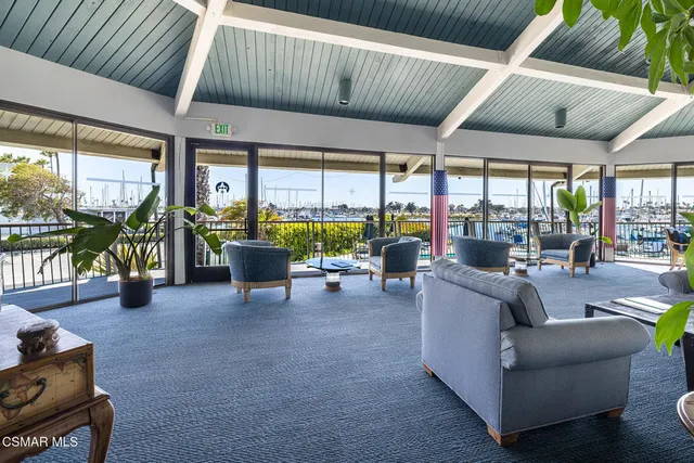 a living room with fireplace furniture and a potted plant