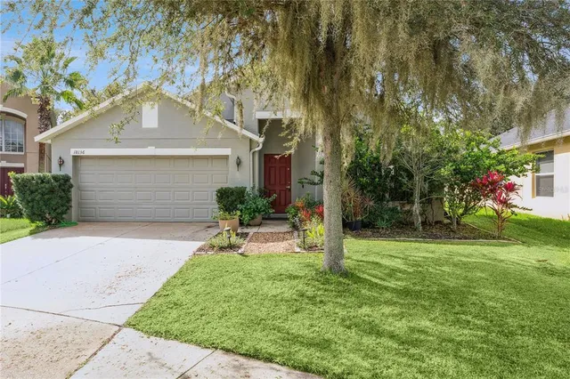 a front view of a house with a yard and garage