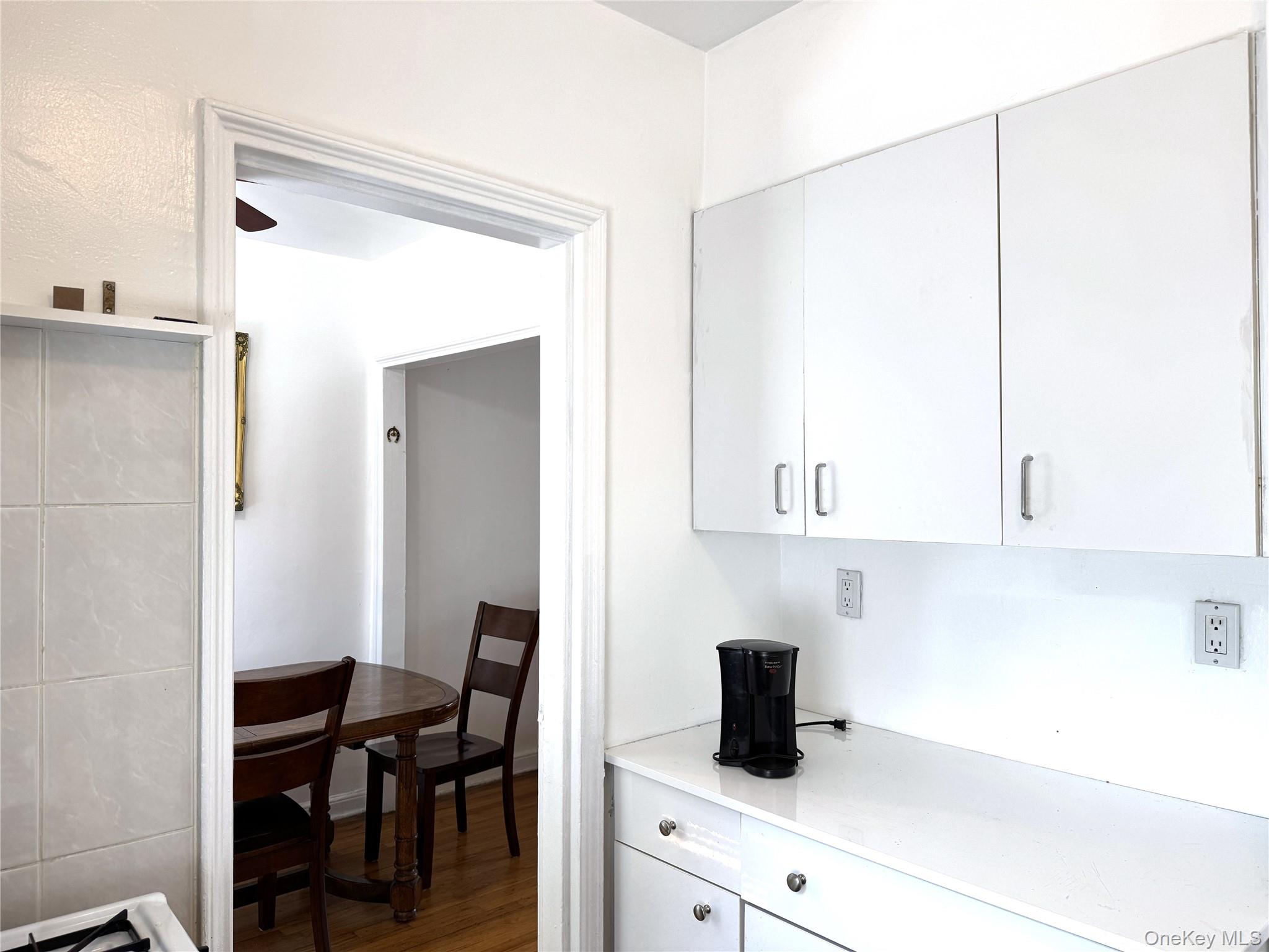 141-24 78th Road, Unit 3A Queens, NY 11367 - Photo 11 of 18 a kitchen with a sink cabinets and a window