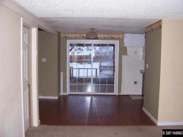 9210 Fremont Way Reno, NV 89506 - Photo 5 of 9 a view of empty room with wooden floor and fan