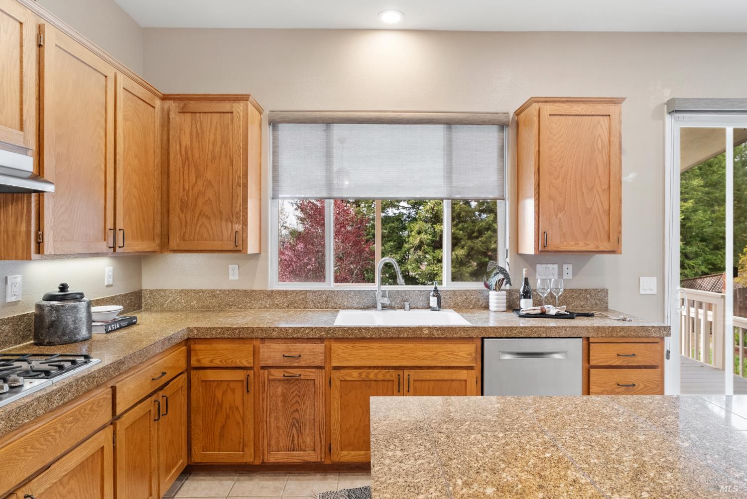 5783 Owl Light Terrace Santa Rosa, CA 95409 - Photo 15 of 51 a kitchen with kitchen island granite countertop a sink a counter top space and cabinets