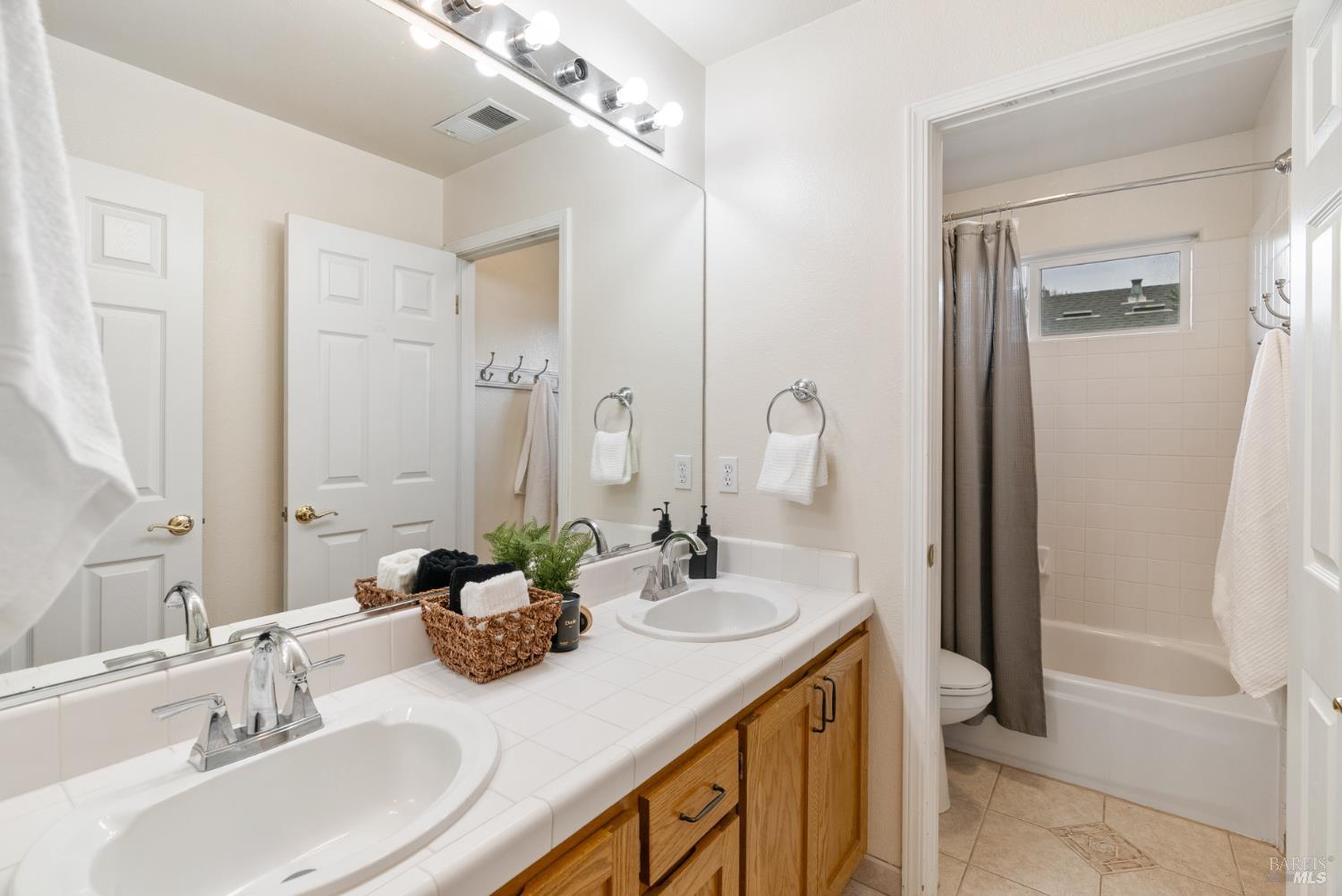 5783 Owl Light Terrace Santa Rosa, CA 95409 - Photo 44 of 51 a bathroom with a double vanity sink and a mirror