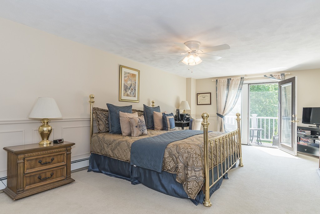 26 Meadow Road Beverly, MA 01915 - Photo 12 of 20 a bedroom with a bed and a chandelier