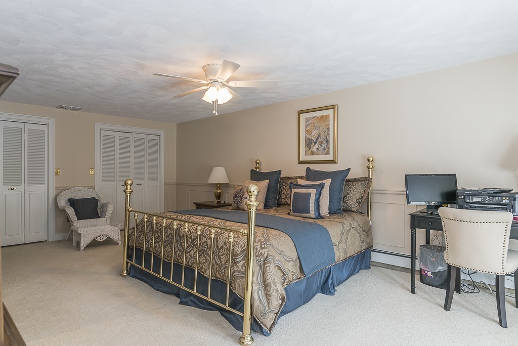 26 Meadow Road Beverly, MA 01915 - Photo 13 of 20 a bedroom with a bed and a chandelier