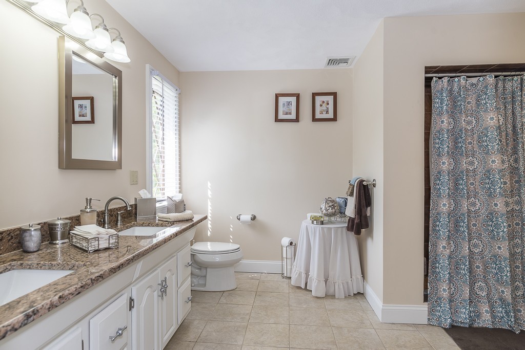 26 Meadow Road Beverly, MA 01915 - Photo 14 of 20 a bathroom with a granite countertop sink mirror and a toilet