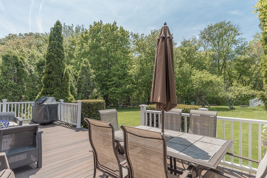 26 Meadow Road Beverly, MA 01915 - Photo 19 of 20 a view of a patio with a table chairs and a barbeque