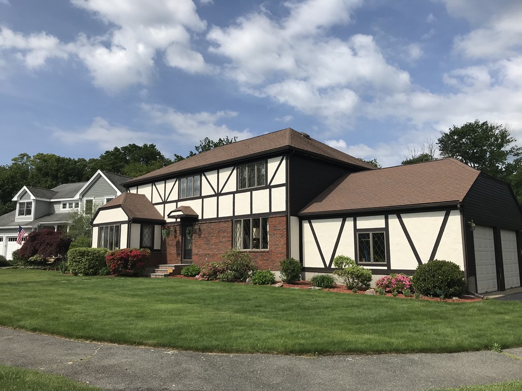 26 Meadow Road Beverly, MA 01915 - Photo 20 of 20 a front view of a house with a garden