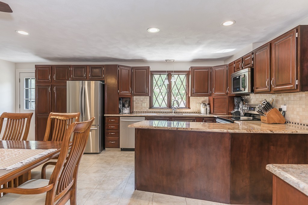 26 Meadow Road Beverly, MA 01915 - Photo 5 of 20 a kitchen with refrigerator and cabinets