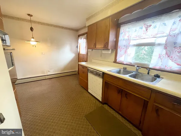 a kitchen with a sink and a refrigerator