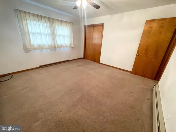 an empty room with a empty space and windows