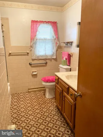 a bathroom with a sink toilet vanity and mirror