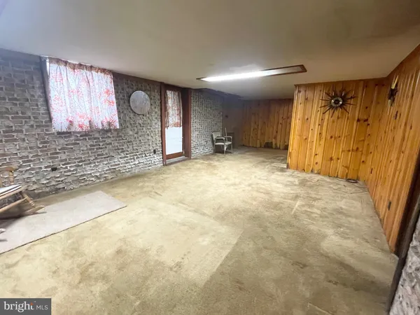 a view of a livingroom with wooden floor and a window