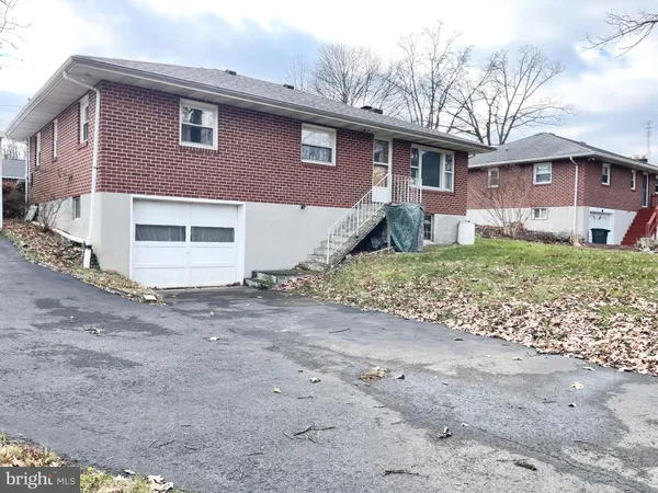 a house that has a tree in front of it