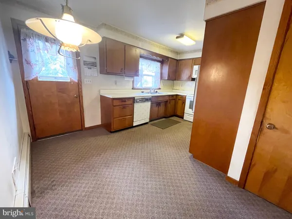 a kitchen with a refrigerator and a stove