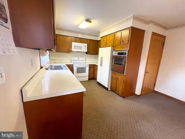 a kitchen with refrigerator and stove