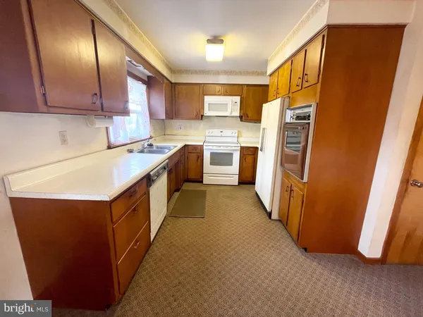 a kitchen with a refrigerator a sink and dishwasher