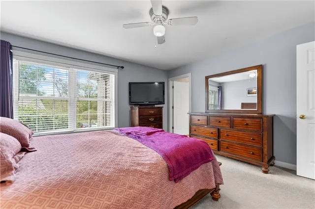 a spacious bedroom with a bed and a dresser