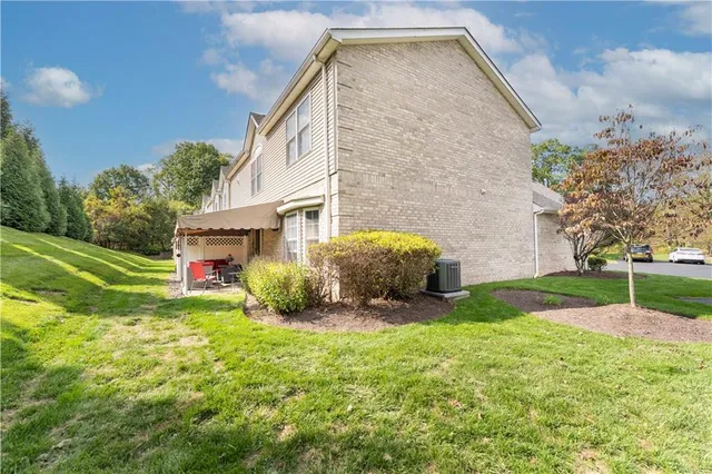 a view of a house with a yard and sitting area