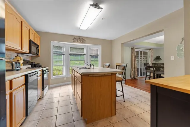 a kitchen with stainless steel appliances granite countertop a stove and a refrigerator