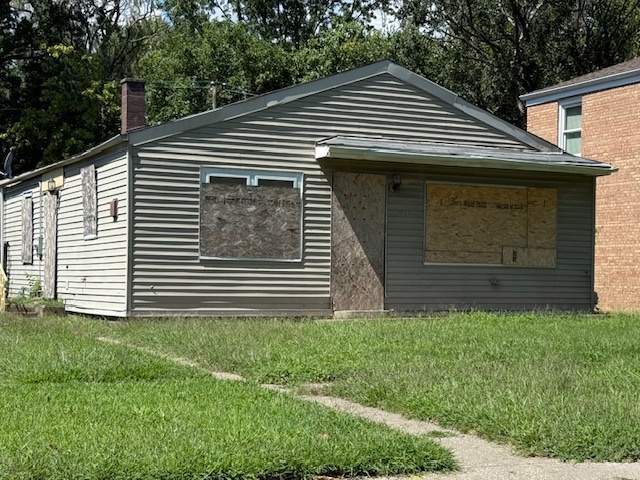 16732 Orchard Ridge Avenue Hazel Crest, IL 60429 - Photo 1 of 2 a front view of a house with a garden