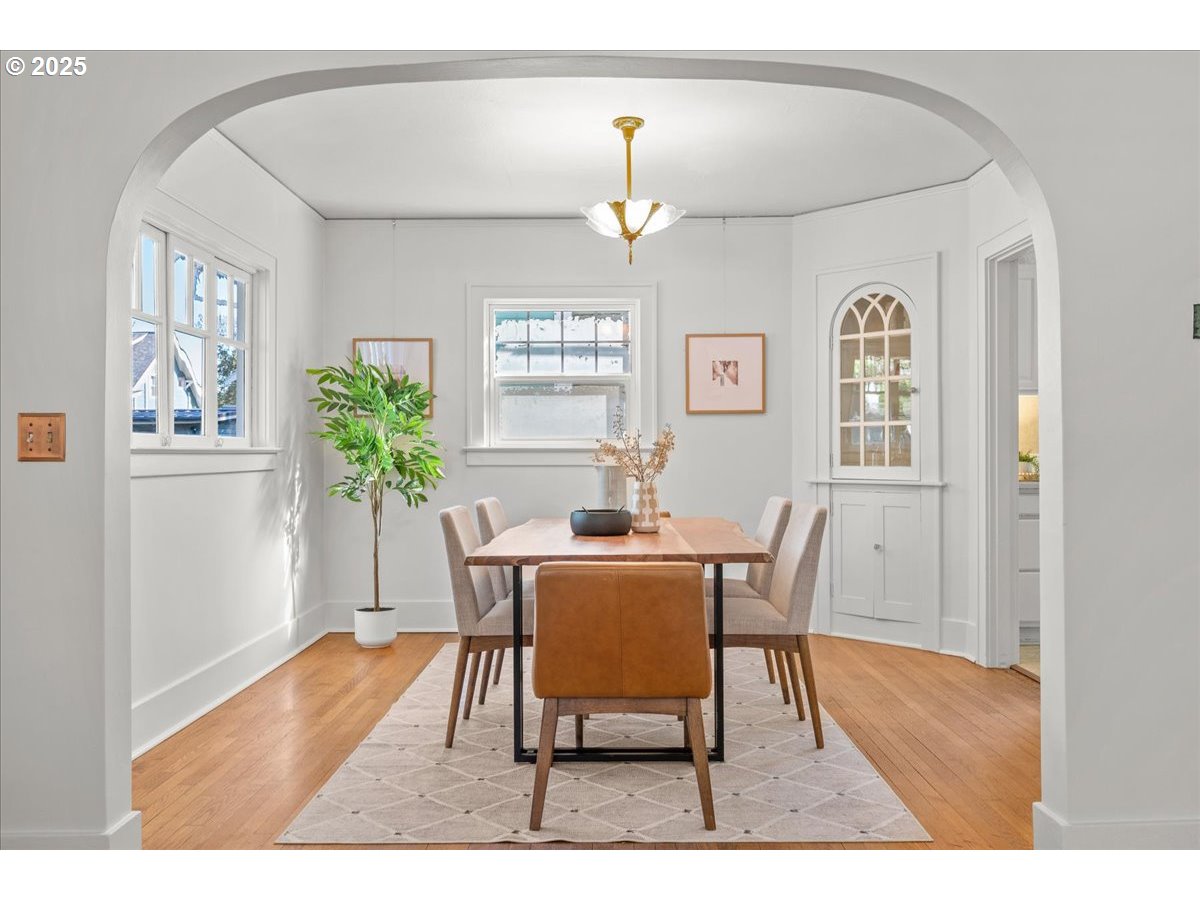 3448 Southeast Sherman Street Portland, OR 97214 - Photo 11 of 40 a view of a dining room with furniture window and wooden floor