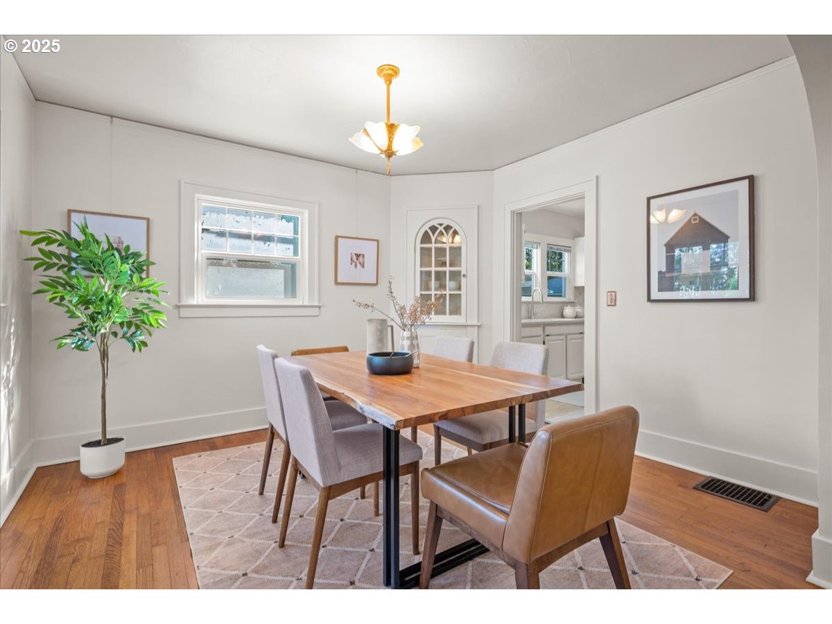 3448 Southeast Sherman Street Portland, OR 97214 - Photo 13 of 40 a view of a dining room with furniture and a chandelier