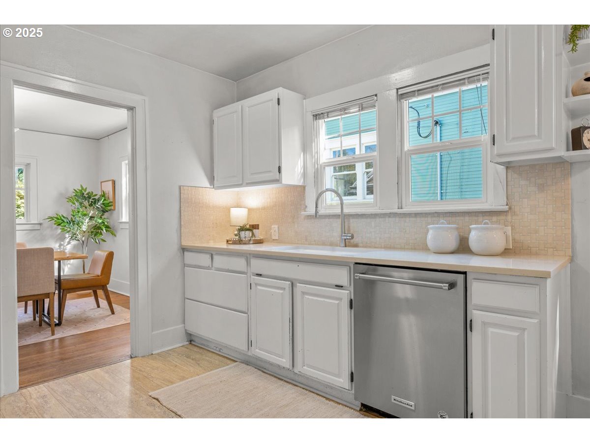 3448 Southeast Sherman Street Portland, OR 97214 - Photo 18 of 40 a kitchen with a sink cabinets and window