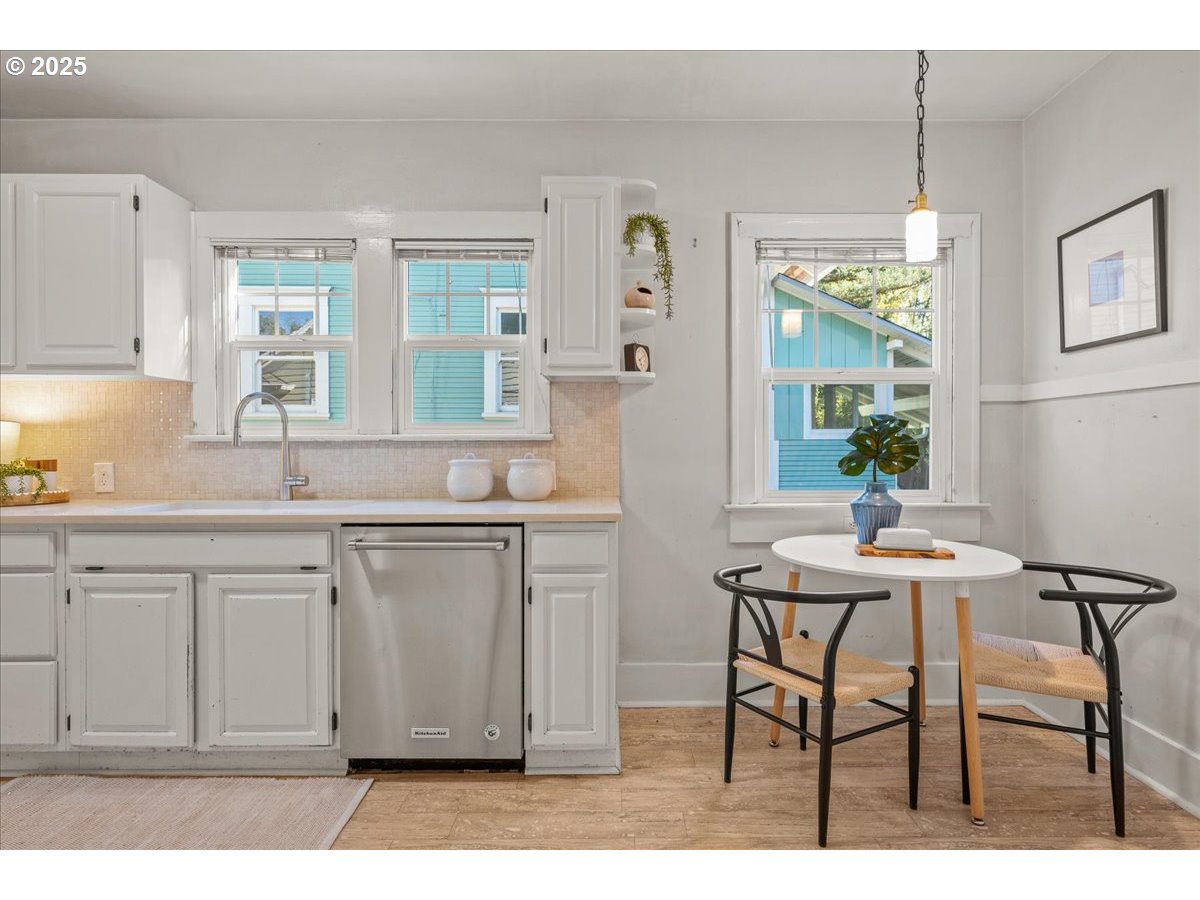 3448 Southeast Sherman Street Portland, OR 97214 - Photo 19 of 40 a kitchen with a sink cabinets and window