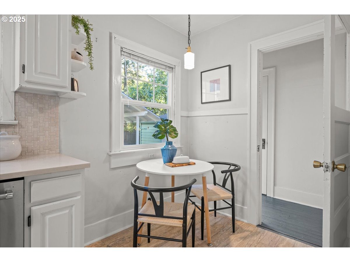 3448 Southeast Sherman Street Portland, OR 97214 - Photo 20 of 40 a view of a dining room with furniture and wooden floor