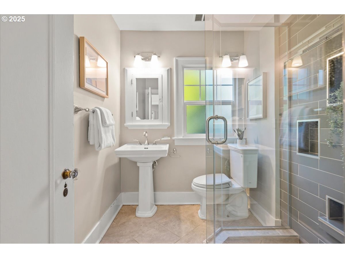 3448 Southeast Sherman Street Portland, OR 97214 - Photo 22 of 40 a bathroom with a sink toilet and shower