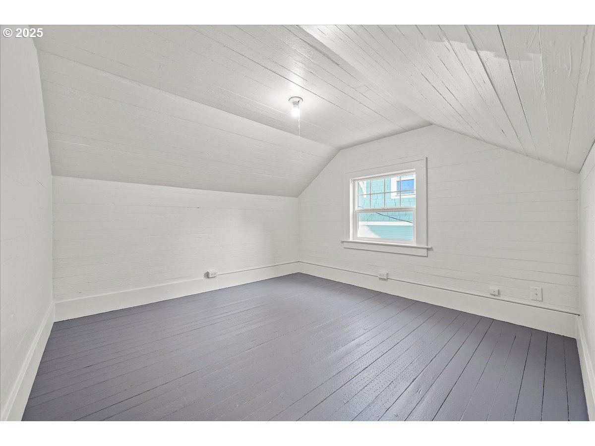3448 Southeast Sherman Street Portland, OR 97214 - Photo 29 of 40 an empty room with wooden floor and windows