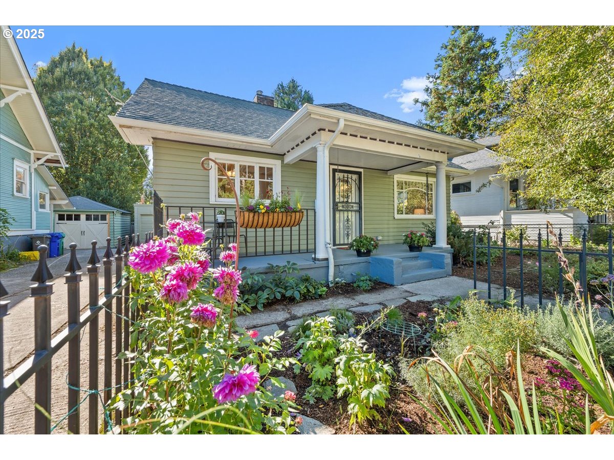 3448 Southeast Sherman Street Portland, OR 97214 - Photo 39 of 40 a front view of a house with a big yard and a fountain
