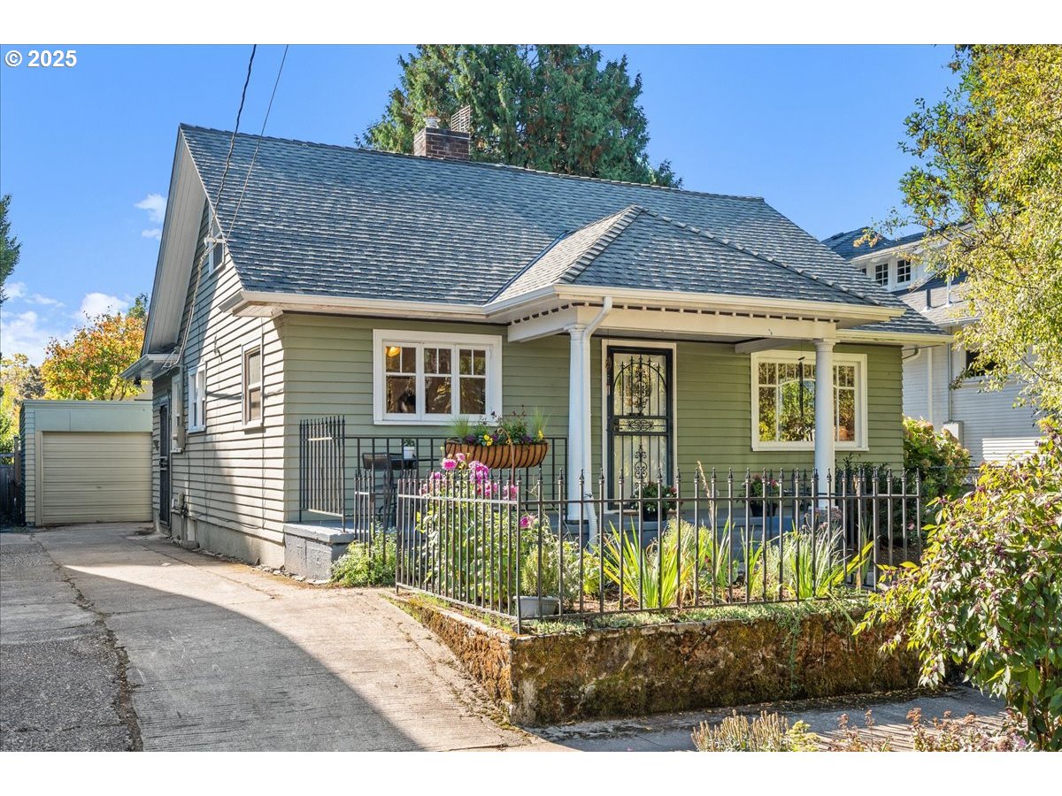 3448 Southeast Sherman Street Portland, OR 97214 - Photo 40 of 40 a front view of a house with garden