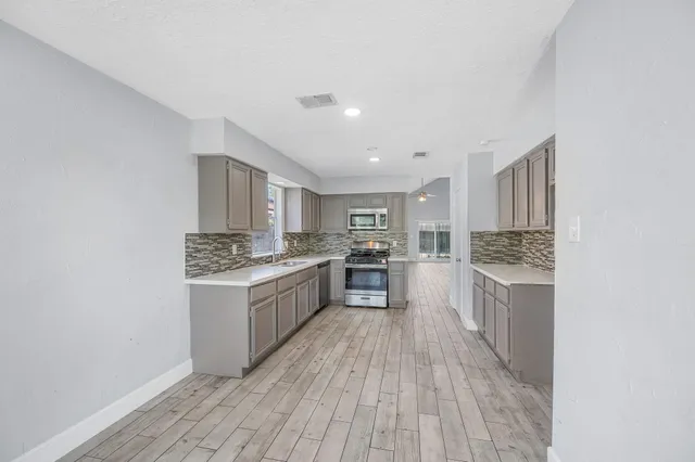 a kitchen with a sink and large window