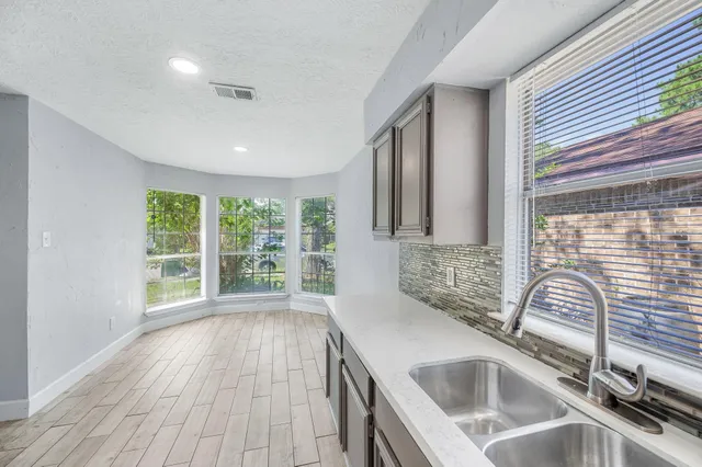 a kitchen with stainless steel appliances granite countertop a stove and a refrigerator