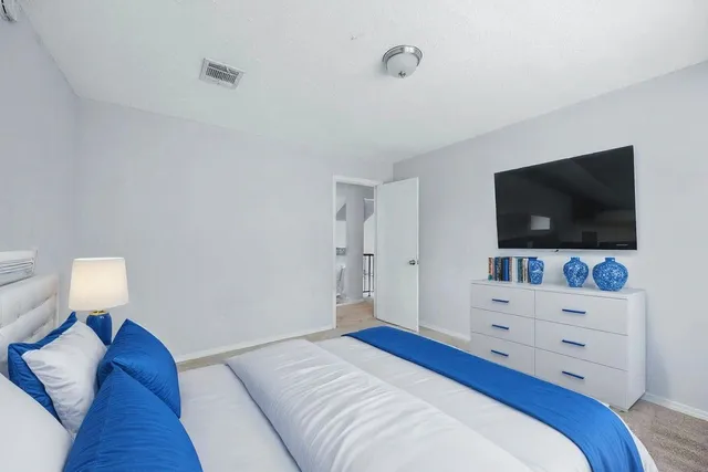 an empty room with a fireplace and a ceiling fan