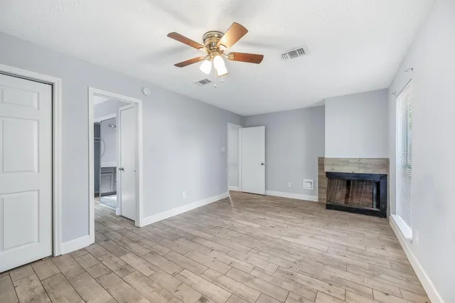 a spacious bathroom with a granite countertop sink a toilet and a mirror