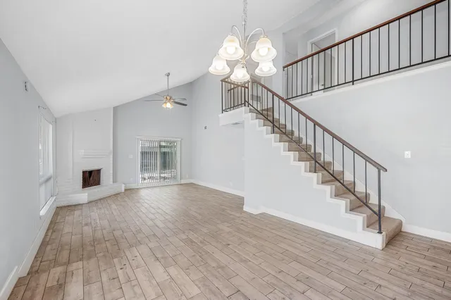 a view of staircase and kitchen with wooden floor