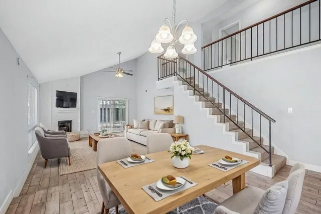 a view of a dining room with furniture a rug and wooden floor