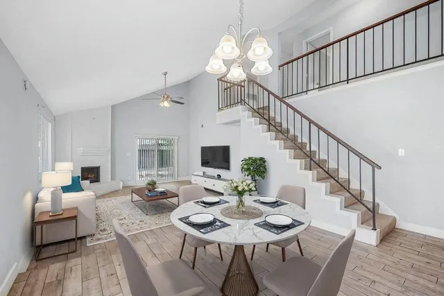 a view of a dining room with furniture a chandelier and wooden floor
