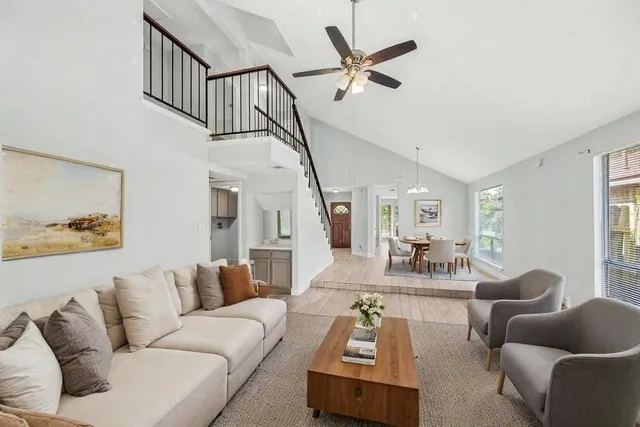 a living room with furniture and a ceiling fan