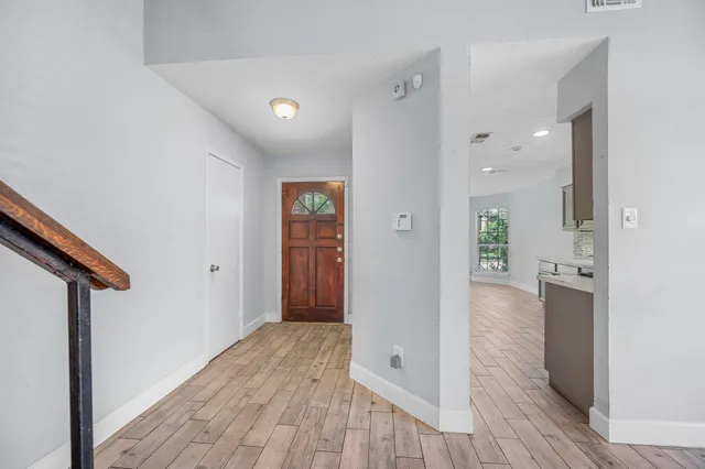a view of hallway with wooden floor