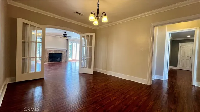a view of a livingroom with wooden floor fireplace and a window