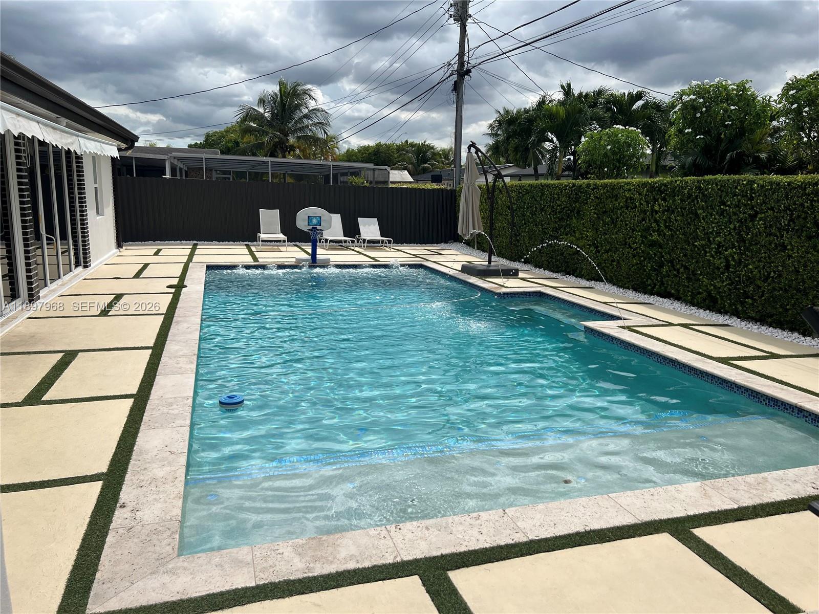 3530 Southwest 126th Avenue Miami, FL 33175 - Photo 17 of 52 a view of a swimming pool with a patio