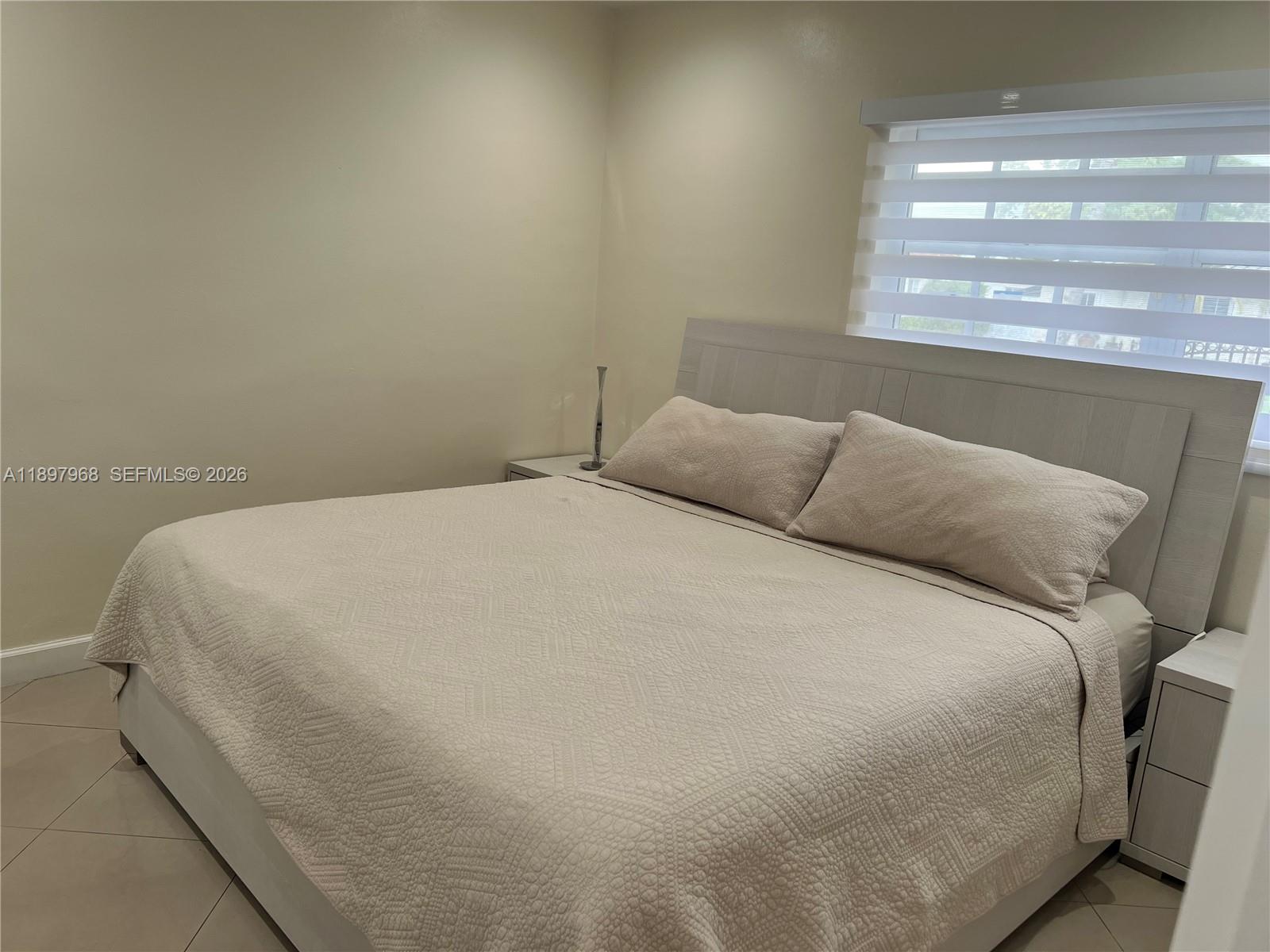3530 Southwest 126th Avenue Miami, FL 33175 - Photo 25 of 52 a large bed sitting in a bedroom next to a window