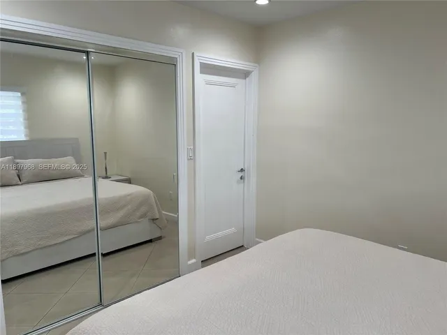 a bedroom with a bed and a television