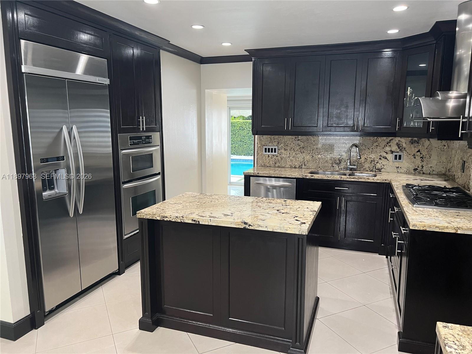 3530 Southwest 126th Avenue Miami, FL 33175 - Photo 38 of 52 a kitchen with a sink stove and refrigerator