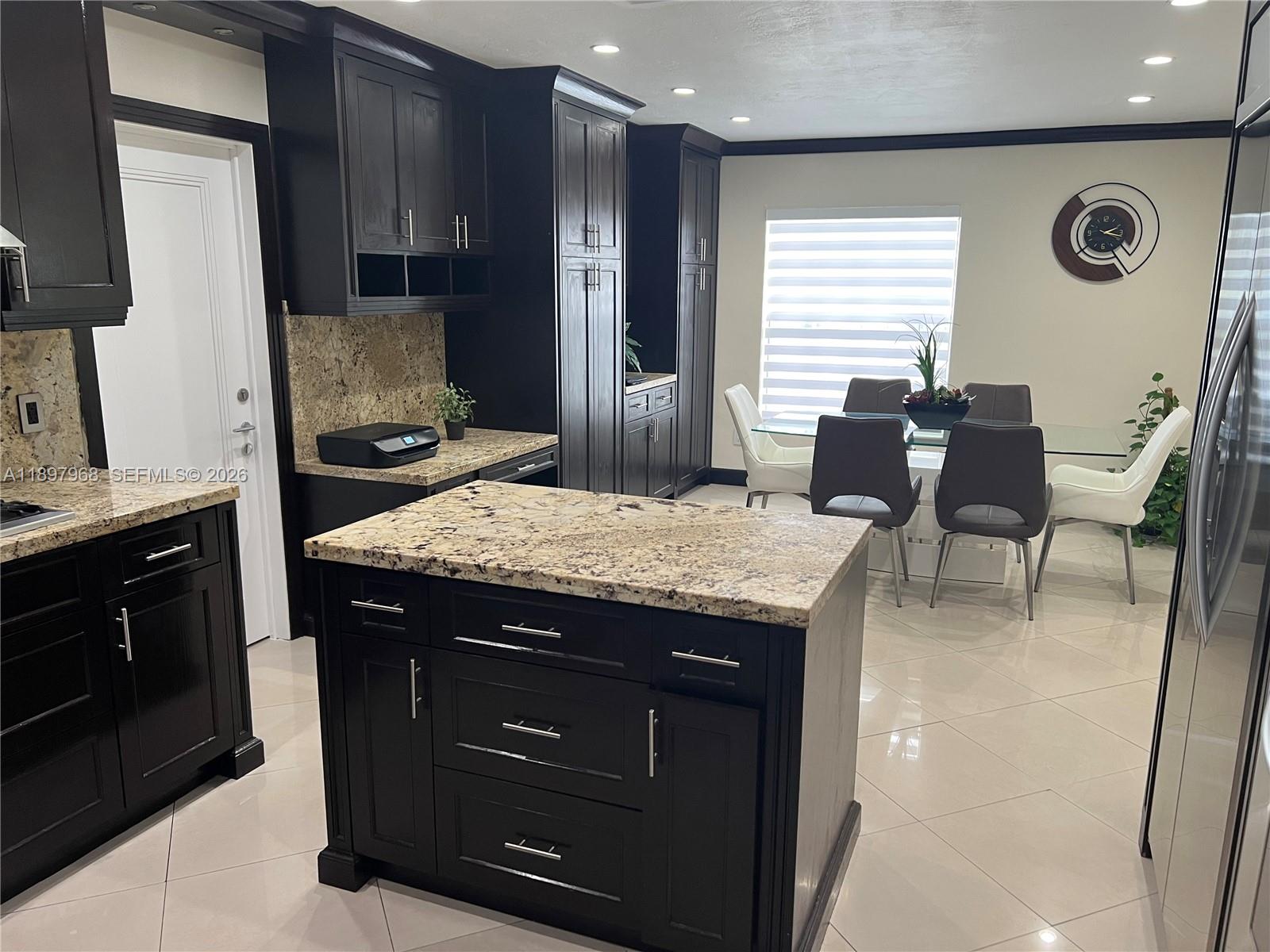 3530 Southwest 126th Avenue Miami, FL 33175 - Photo 39 of 52 a kitchen with a sink a stove a refrigerator and chairs