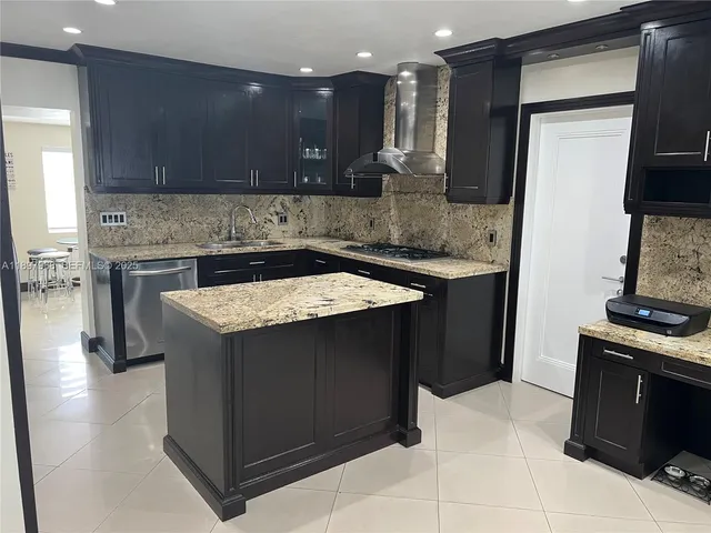 a living room with furniture and view of kitchen