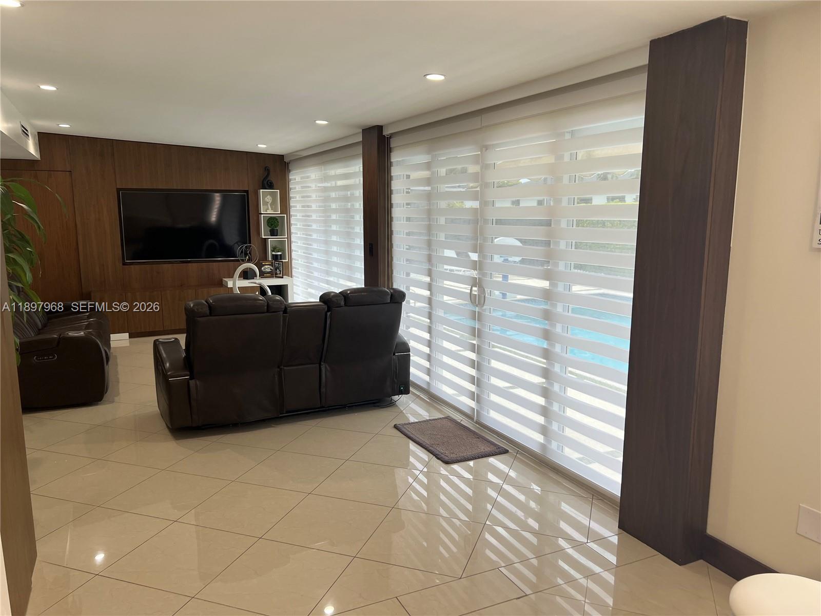 3530 Southwest 126th Avenue Miami, FL 33175 - Photo 44 of 52 a living room with furniture and a flat screen tv